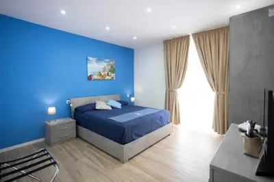 Letto o letti in una camera di GIULY SUITES & ROOMS