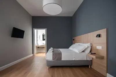 Letto o letti in una camera di Nolana 28 Rooms in Naples
