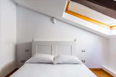 Letto o letti in una camera di Attico al Duomo by Napoliapartments