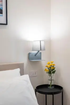 Letto o letti in una camera di Well Suites - Piazza dei Martiri