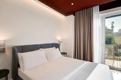 Letto o letti in una camera di Well Suites - Piazza dei Martiri