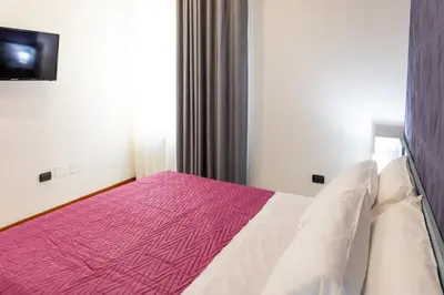 Letto o letti in una camera di May Flower Luxury