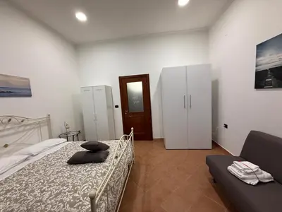 Letto o letti in una camera di Il golfo di Partenope