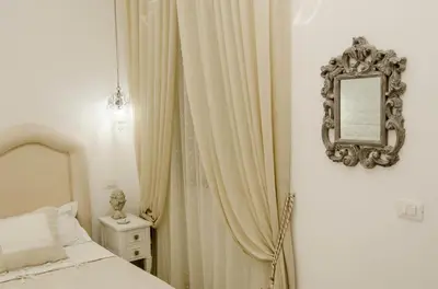 Letto o letti in una camera di Domus Rosa