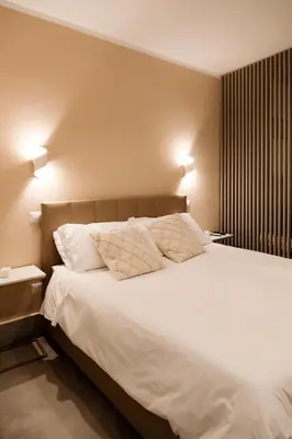 Letto o letti in una camera di ADOUNIA HOME
