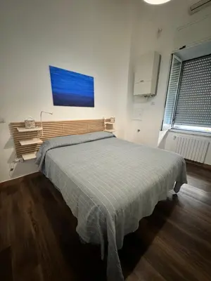 Letto o letti in una camera di Riviera Apartment Napoli