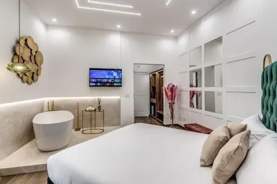 Letto o letti in una camera di ATAROOMS Suites Napoli