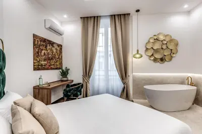 Letto o letti in una camera di ATAROOMS Suites Napoli
