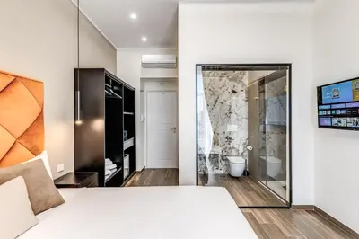 Letto o letti in una camera di ATAROOMS Suites Napoli