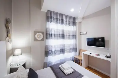 Letto o letti in una camera di Vomero Grandi Residenze Napoli