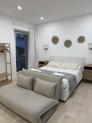 Letto o letti in una camera di HV Suites TRIBUNALIUM