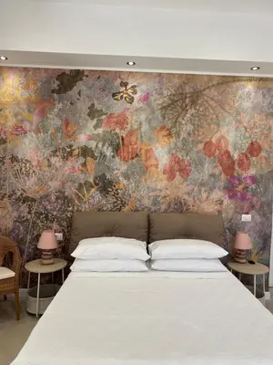 Letto o letti in una camera di Napoli centro madame Naples con terrazzo e vista giardino