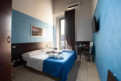 Letto o letti in una camera di Napolì Affittacamere