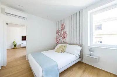 Letto o letti in una camera di NUOVO appartamento nel cuore di Napoli AT TWENTY ONE - CORAL