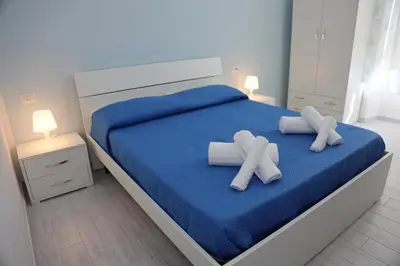 Letto o letti in una camera di B&B Mimela Napoli