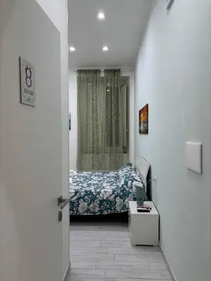 Letto o letti in una camera di B&B Mimela Napoli