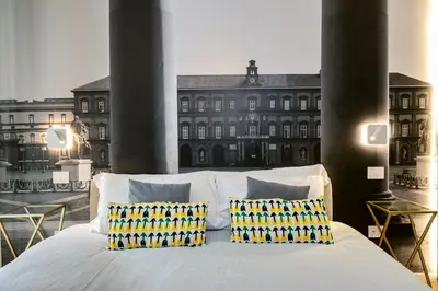 Letto o letti in una camera di NILO RELAIS a san domenico maggiore