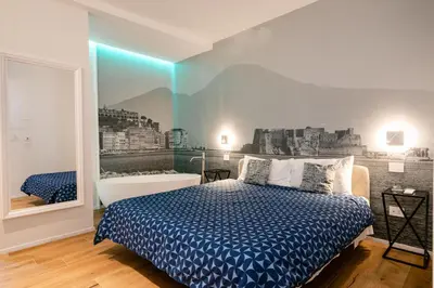 Letto o letti in una camera di NILO RELAIS a san domenico maggiore