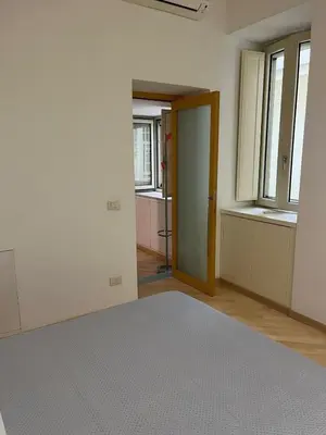 Letto o letti in una camera di Napolina House - Chiaia