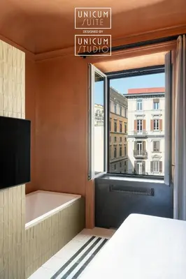 Letto o letti in una camera di Unicum Suite Grande Archivio Napoli Centro Storico