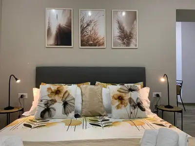 Letto o letti in una camera di La casa di Bianca - modern suites near Plebiscito