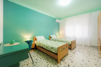 Letto o letti in una camera di Casa Spaziosa, a pochi passi da Metro e Centro