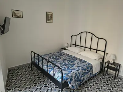 Letto o letti in una camera di Domus Archivii