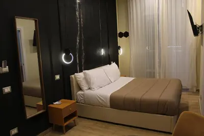 Letto o letti in una camera di BlackWoody Contemporary Rooms - Napoli Centro Storico Via Toledo