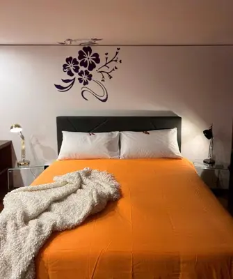 Letto o letti in una camera di Ann' Amarì Arancione