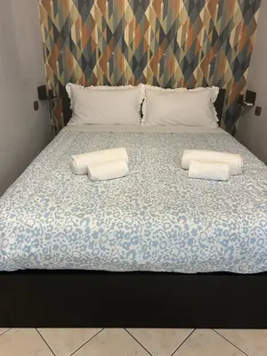 Letto o letti in una camera di suite di Peppe Napoli Centro