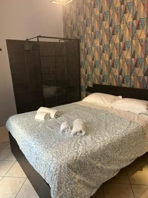 Letto o letti in una camera di suite di Peppe Napoli Centro