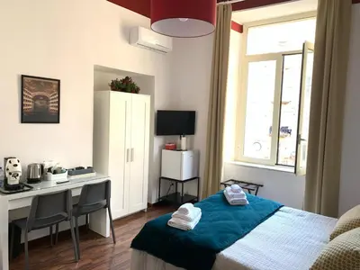 Letto o letti in una camera di La finestra su Napoli