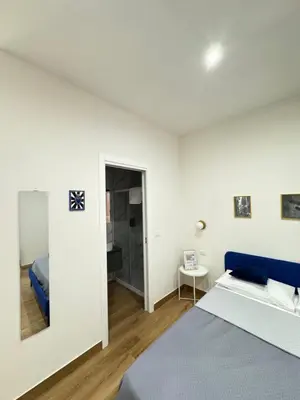 Letto o letti in una camera di Neapolitan Suites
