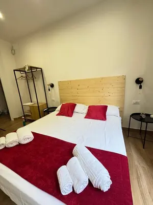 Letto o letti in una camera di Neapolitan Suites