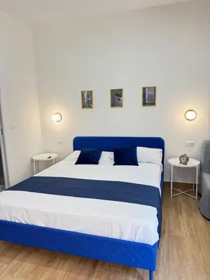 Letto o letti in una camera di Neapolitan Suites