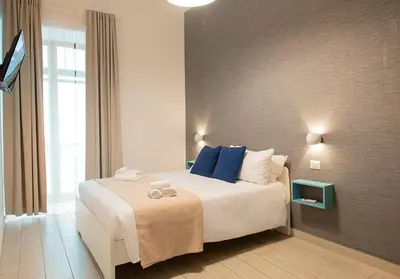 Letto o letti in una camera di MIGLIO SACRO Suites