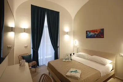 Letto o letti in una camera di Le chiavi di Parthenope