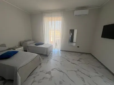 Letto o letti in una camera di Napoli City