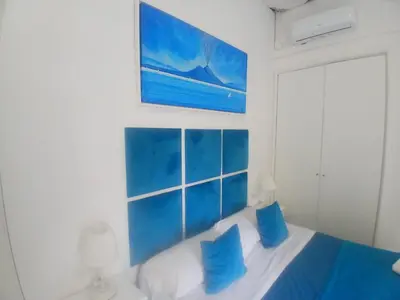 Letto o letti in una camera di Neapolis Rooms Santa Lucia