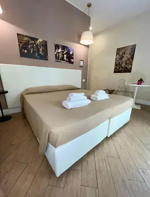 Letto o letti in una camera di de Ribera rooms in Naples