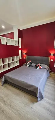 Letto o letti in una camera di Rosso Vesuvio