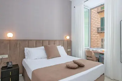 Letto o letti in una camera di Hotel Odeon Napoli