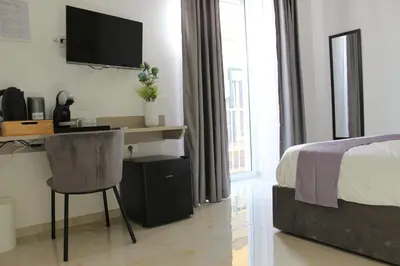 Letto o letti in una camera di Le Coccinelle - B&B Napoli