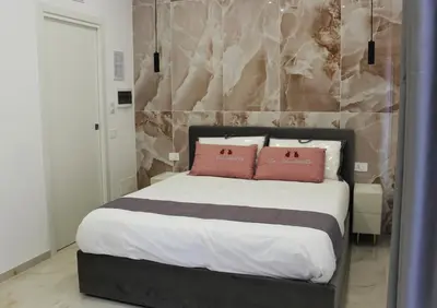 Letto o letti in una camera di Le Coccinelle - B&B Napoli