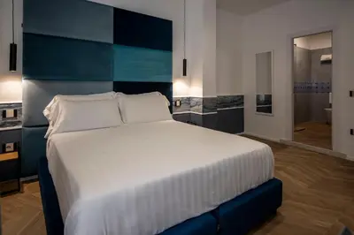 Letto o letti in una camera di Hotiday Napoli Vittorio Emanuele