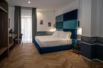 Letto o letti in una camera di Hotiday Napoli Vittorio Emanuele