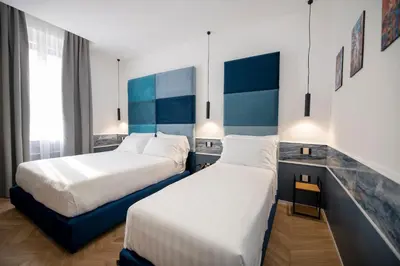 Letto o letti in una camera di Hotiday Napoli Vittorio Emanuele