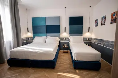 Letto o letti in una camera di Hotiday Napoli Vittorio Emanuele
