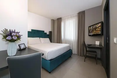 Letto o letti in una camera di Hotiday Napoli Porto