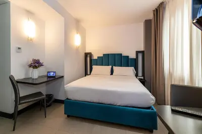 Letto o letti in una camera di Hotiday Napoli Porto